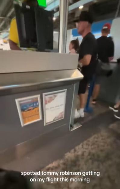 Tommy Robinson at an airport check-in.