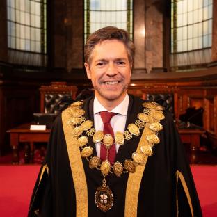 Portrait of a man wearing a mayoral chain of office.