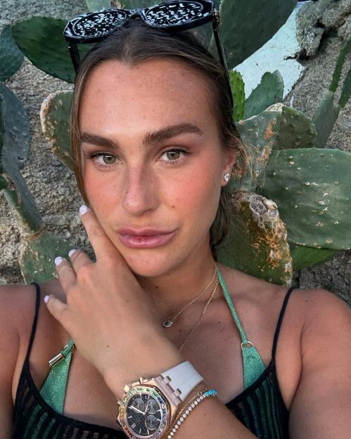 Aryna Sabalenka wearing a watch and jewelry, posing for a selfie.