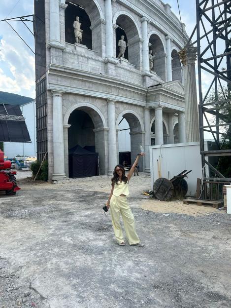 Michelle Keegan filming in Bulgaria in front of a Roman-style set.