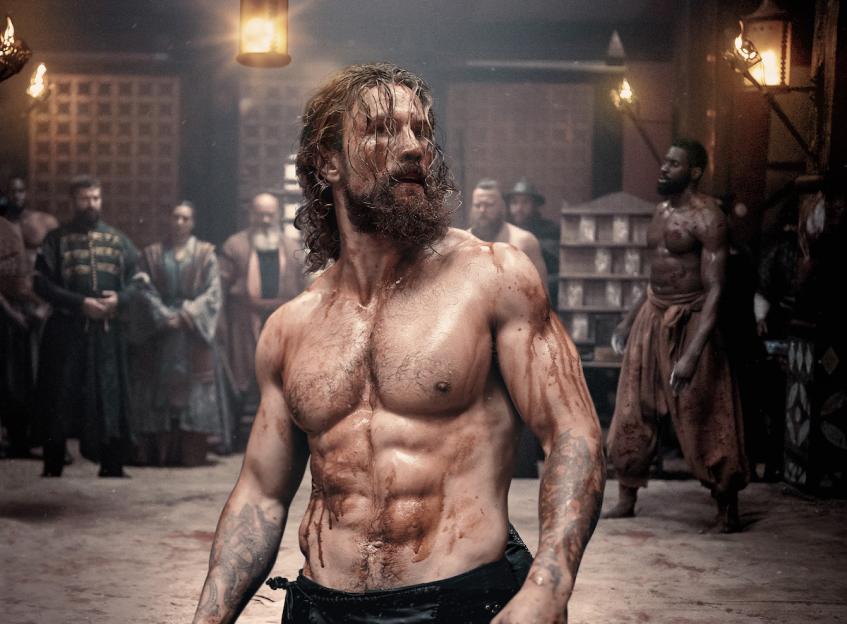 Leo Suter as a bloody Viking in Netflix's *Vikings*.