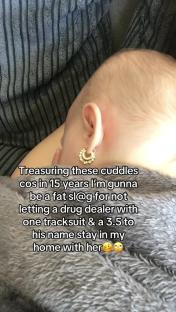 Baby wearing hoop earrings.