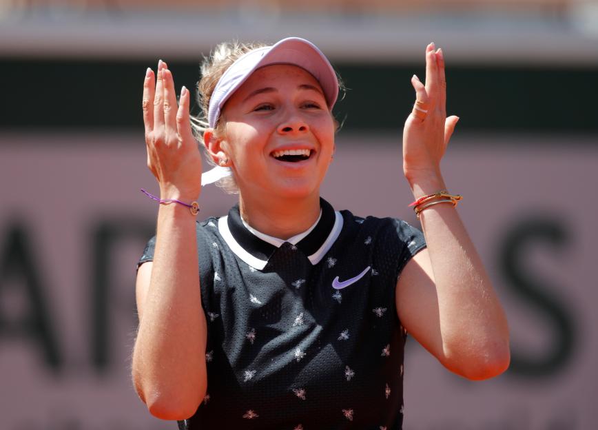 Amanda Anisimova celebrates after a tennis match.