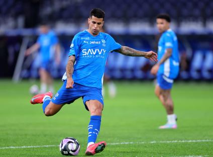 Joao Cancelo of Al Hilal warming up before a soccer match.