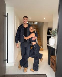 Couple embracing in a hallway.