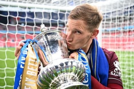 Marc Albrighton of Leicester City kissing the Emirates FA Cup trophy.