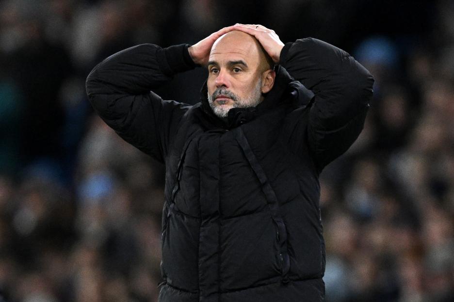 Pep Guardiola, manager of Manchester City, looking dejected.