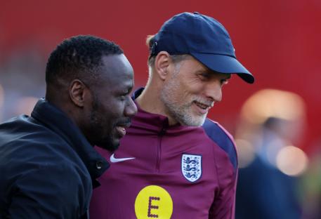 Senegal coach Pape Thiaw and England manager Thomas Tuchel talking.