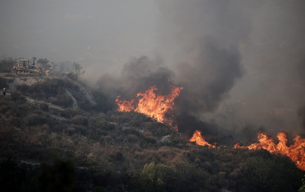Wildfire burning on a hillside.