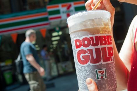 Person drinking a 7-Eleven Double Gulp.