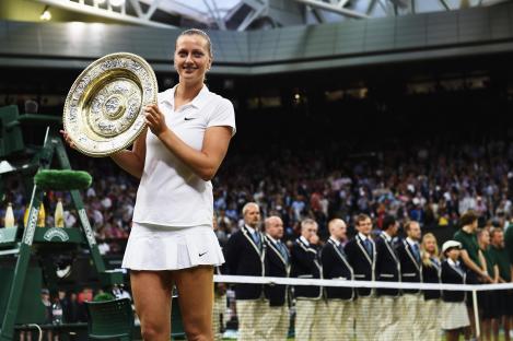 Petra Kvitova holding the Venus Rosewater Dish trophy at Wimbledon.