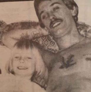Black and white photo of Kevin Childerley and his young daughter.