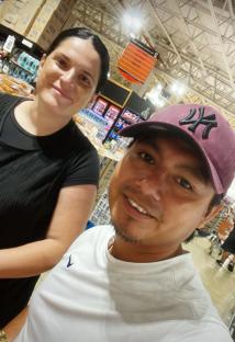 Couple smiling for a selfie in a store.
