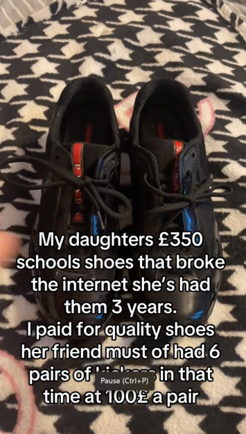 A pair of black Prada school shoes.