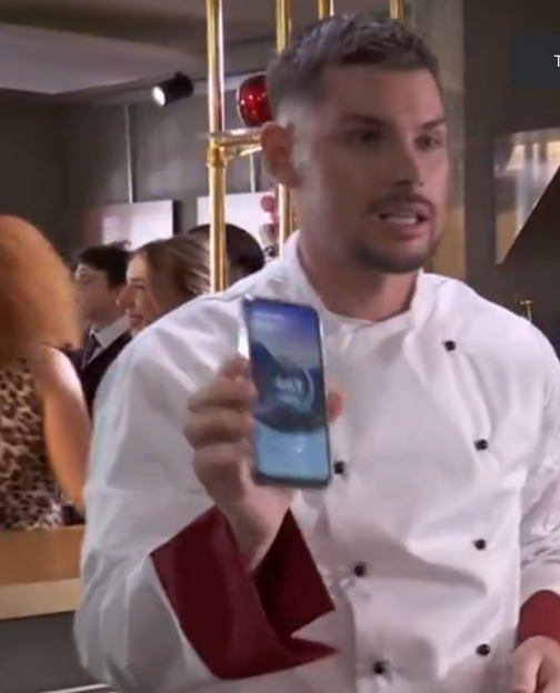 Chef showing a smartphone.