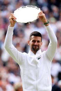 Novak Djokovic holding the Wimbledon runner-up trophy.