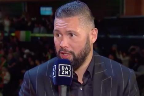 Man in suit being interviewed with a microphone.