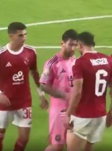 Lionel Messi appearing to headbutt an opponent during a soccer match.