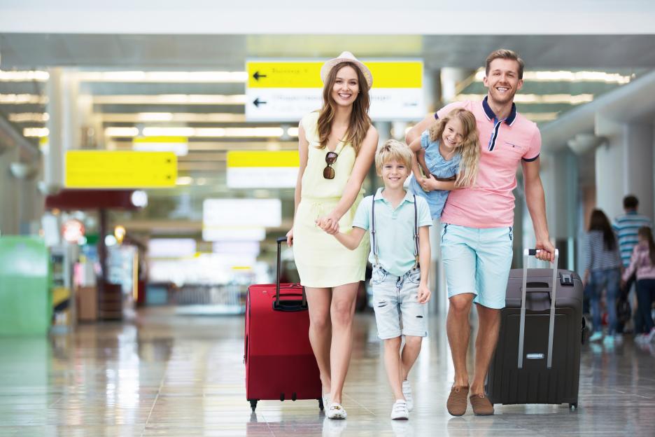 Family with luggage at the airport.