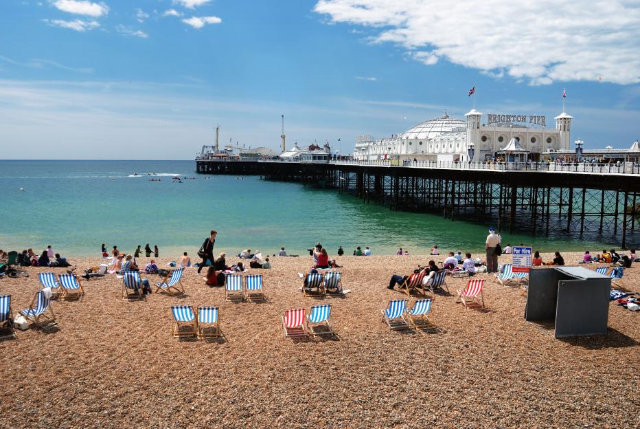 Tourists enjoying Brighton Beach and pier.