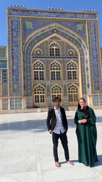 Woman and man standing in front of an ornate building.