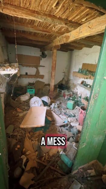 A messy, cluttered room with debris and old bottles.