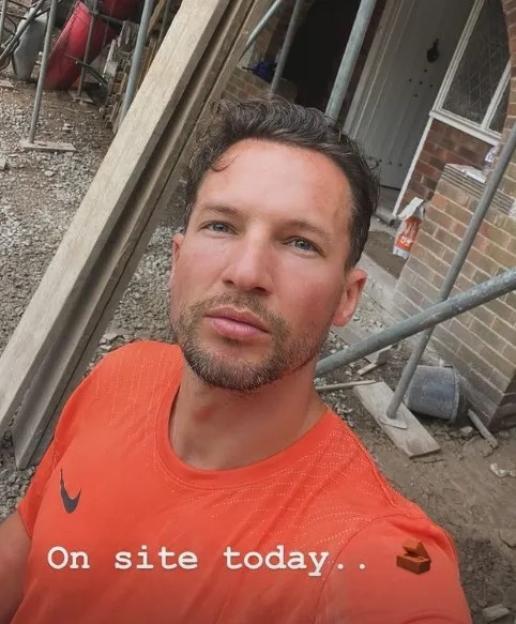 Man in orange shirt on a construction site.