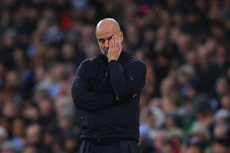 Pep Guardiola, manager of Manchester City, looking dejected.