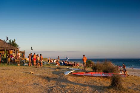 People relaxing at a beach bar in Tarifa, Spain.