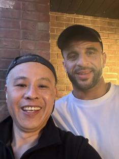 Photo of two men smiling for a selfie.