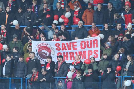 Morecambe fans protest with a banner reading