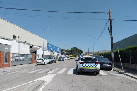 Street scene of parked cars near a police vehicle.