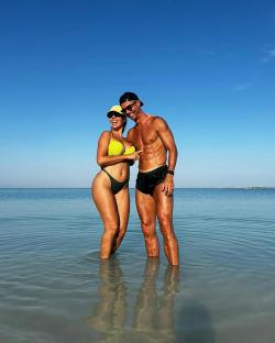 Georgina Rodriguez and Cristiano Ronaldo in shallow water.