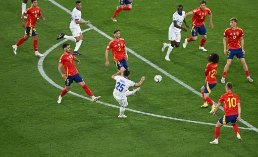 Rayan Cherki scoring a goal during a soccer match.
