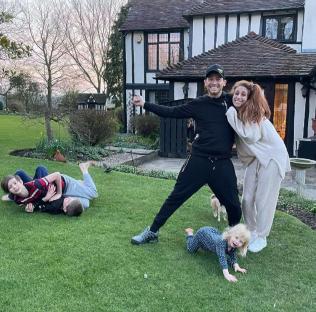 Family in front of their new home.