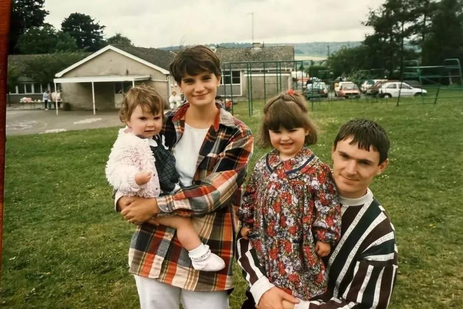 Photo of a family with two young girls and their parents.