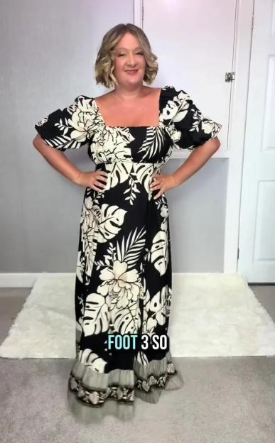 Woman in a black and white floral maxi dress.