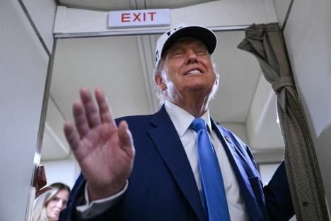 President Trump aboard Air Force One, waving.
