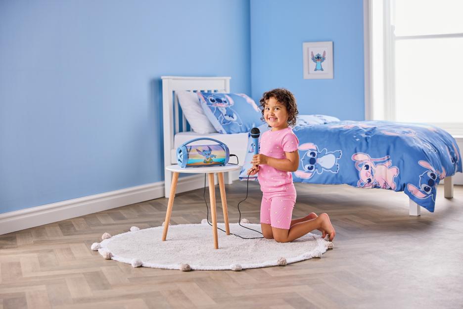 Girl singing with Lilo & Stitch karaoke set.