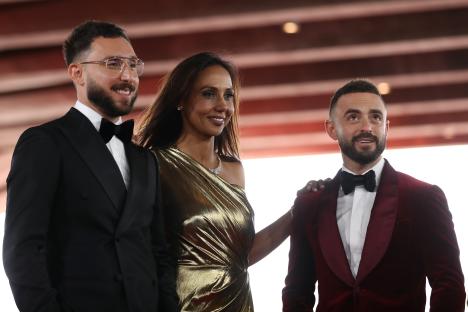 Three people posing for a photo at an awards ceremony.