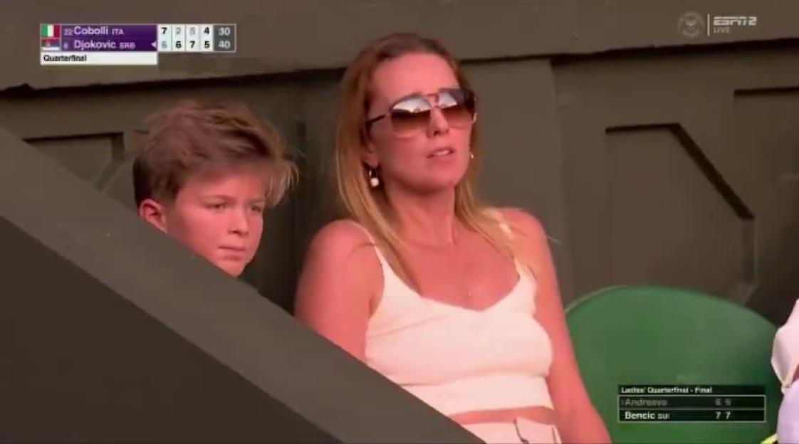 Jelena Djokovic and her son watching a tennis match.