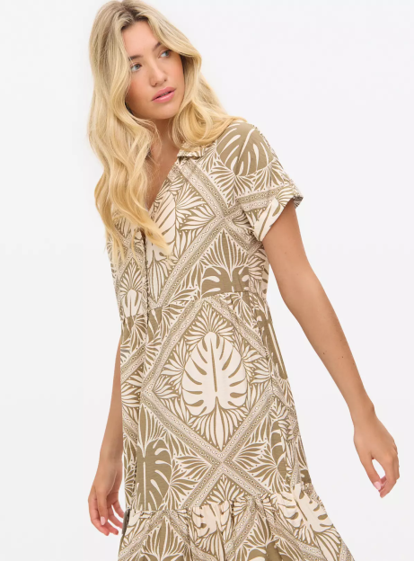 Woman wearing a beige and brown patterned midi dress.