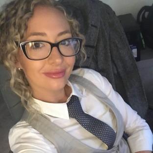Selfie of a woman wearing glasses and a tie.