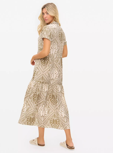 Woman in a patterned midi dress viewed from behind.