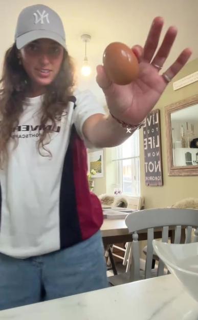 Woman holding an egg.