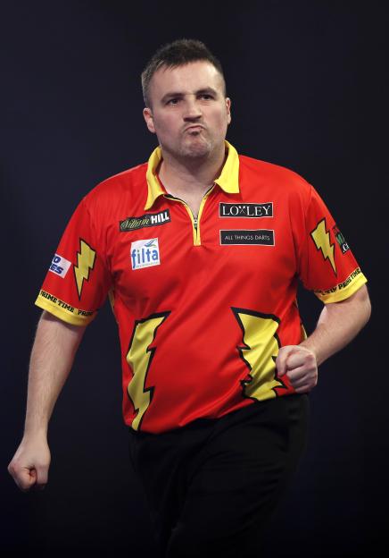 Matthew Edgar of England reacts during a darts match.