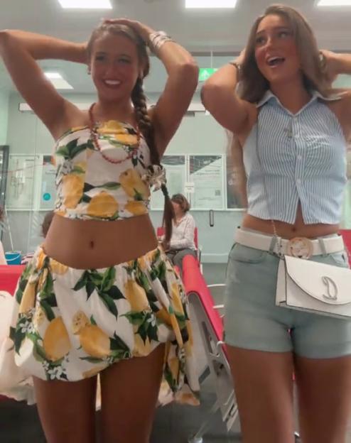 Two young women posing in summer outfits.