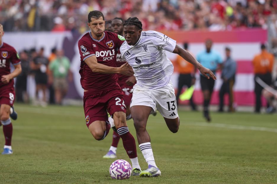West Ham United's Guido Rodriguez and Manchester United's Patrick Chinazaekpere Dorgu competing for the ball during a soccer match.