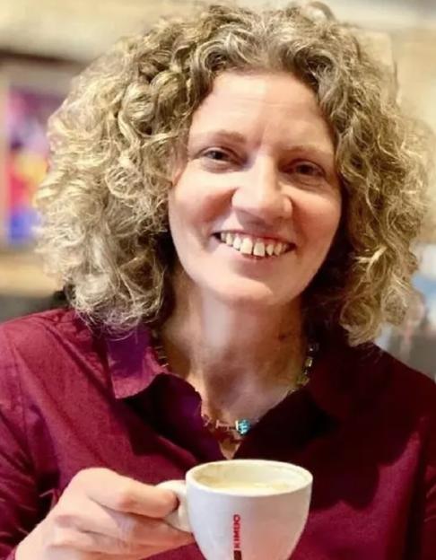Lynda Shahwan, BBC journalist, holding a coffee cup.