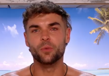 Screenshot of a man speaking.